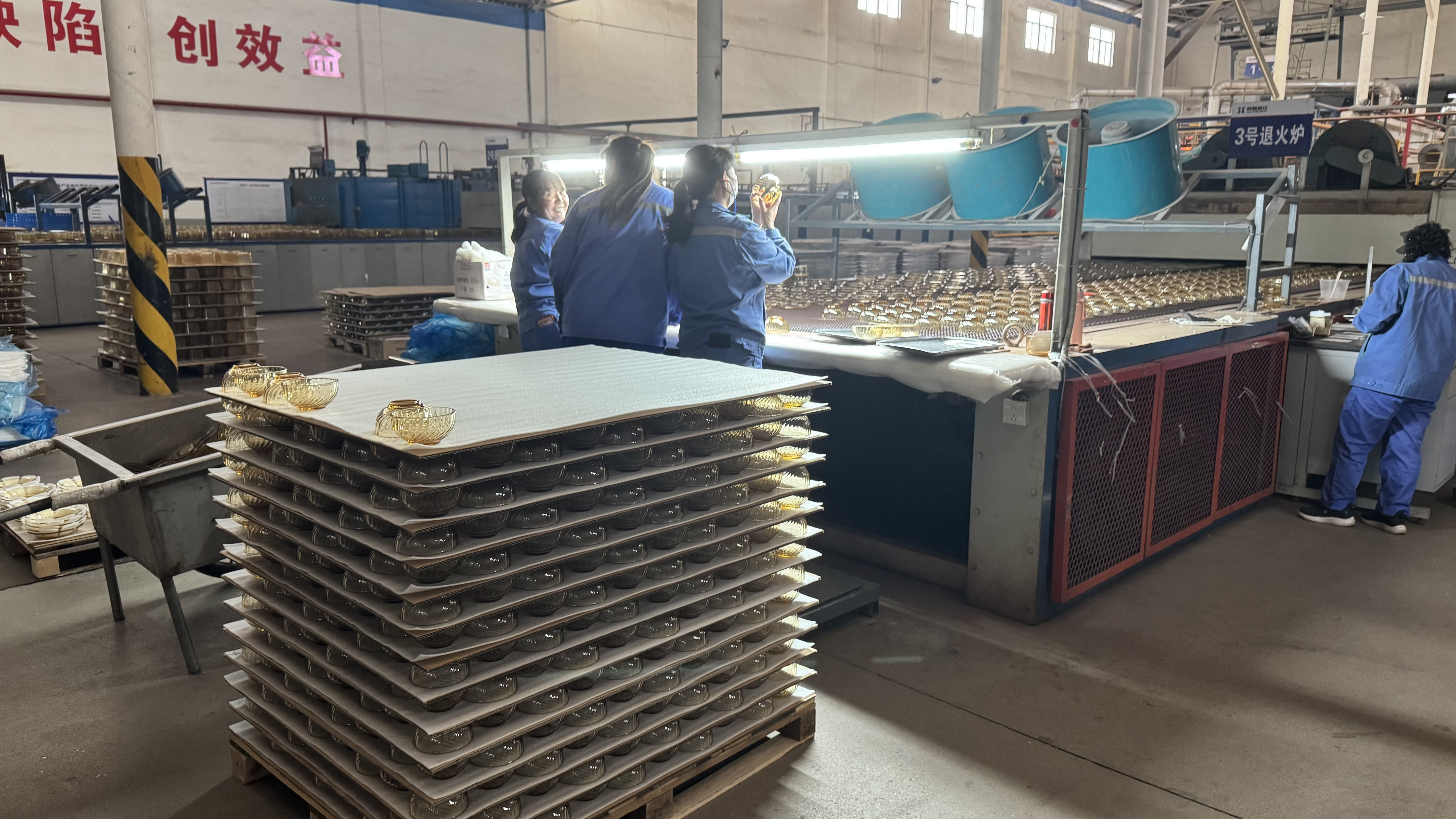 Worker inspecting glassware at the factory