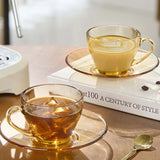 Lead-free and non-toxic amber glass cup and saucer set with precision machine-made finish.