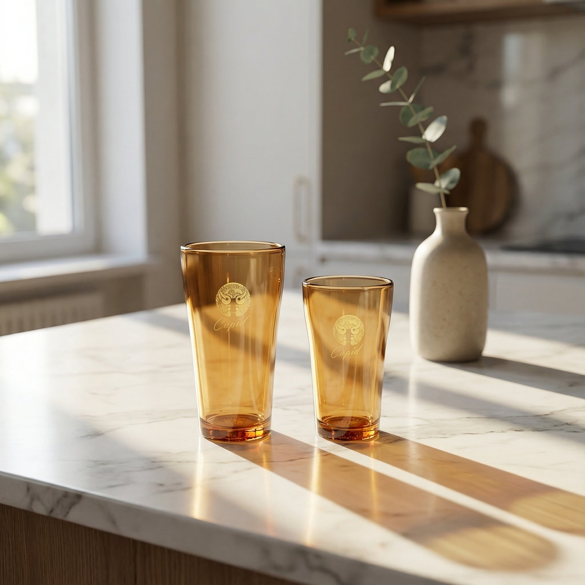Sienna Glow amber borosilicate glass tumbler with gold Cupid decal available in 12oz and 17oz sizes.SOLA & SIENNA