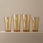 Sienna Glow amber borosilicate glass tumbler with gold Cupid decal available in 12oz and 17oz sizes.SOLA & SIENNA