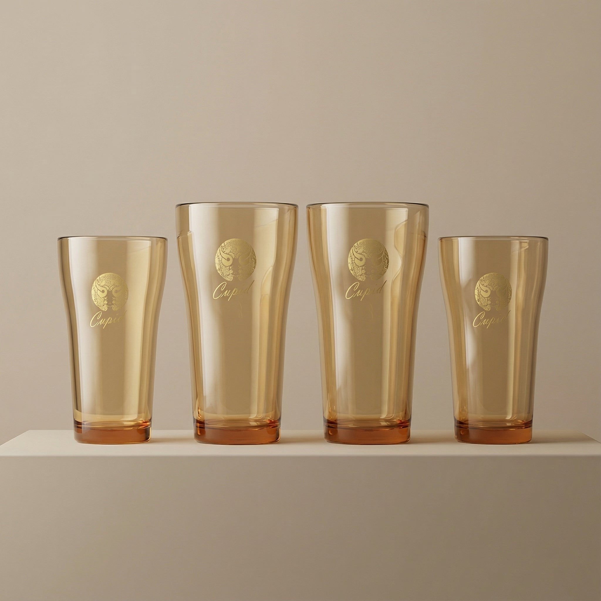 Sienna Glow amber borosilicate glass tumbler with gold Cupid decal available in 12oz and 17oz sizes.SOLA & SIENNA