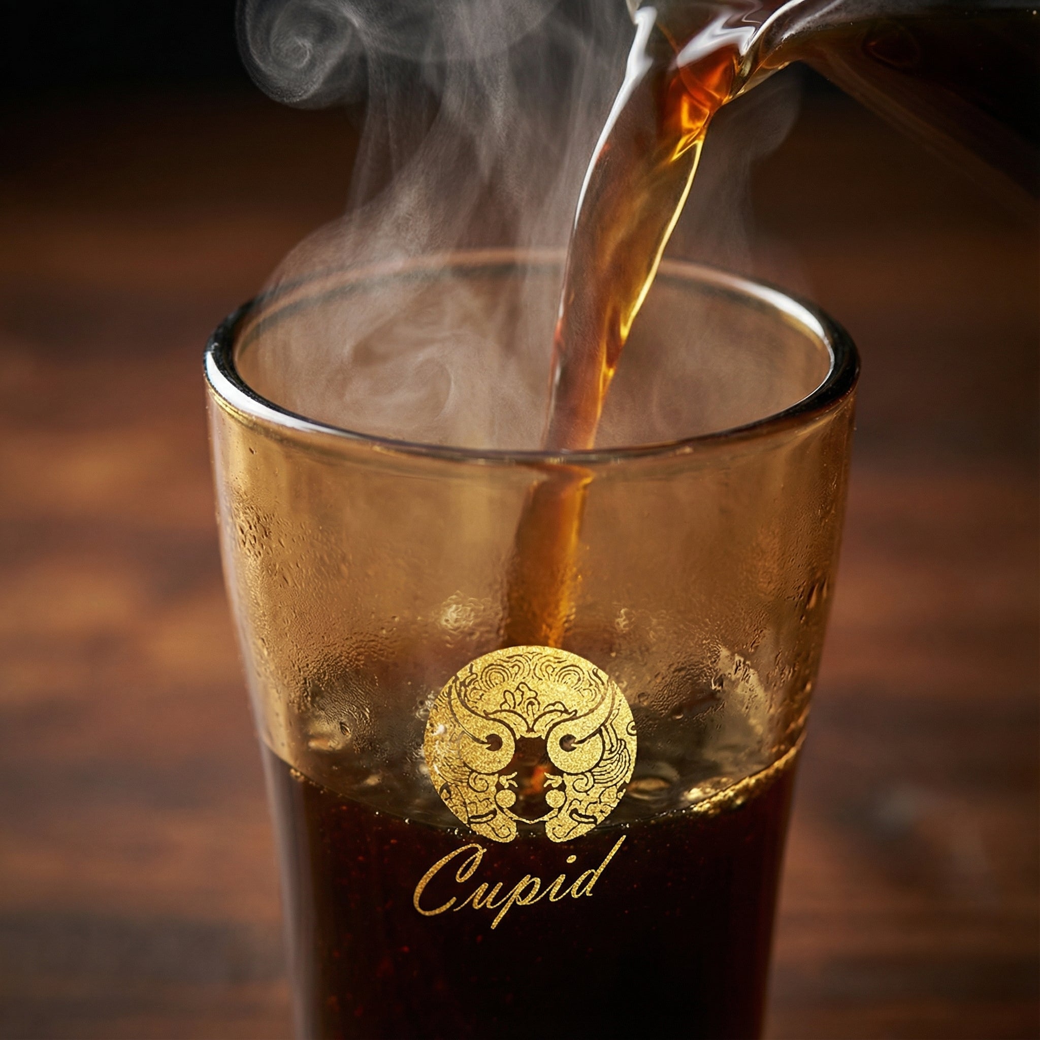 Sienna Glow amber borosilicate glass tumbler with gold Cupid decal available in 12oz and 17oz sizes.SOLA & SIENNA