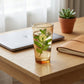 Sienna Glow amber borosilicate glass tumbler with gold Cupid decal available in 12oz and 17oz sizes.SOLA & SIENNA