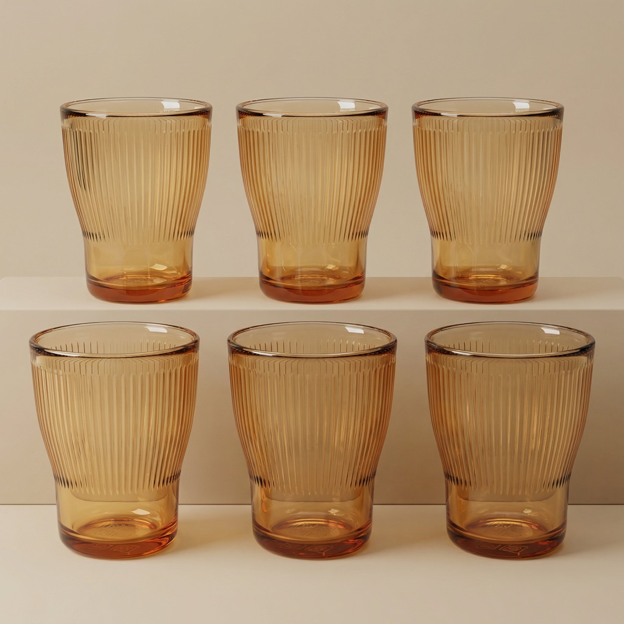 Sienna Glow ribbed amber glass tumbler made of heat-resistant borosilicate glass with elegant vertical texture.SOLA & SIENNA