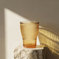 Sienna Glow ribbed amber glass tumbler made of heat-resistant borosilicate glass with elegant vertical texture.SOLA & SIENNA