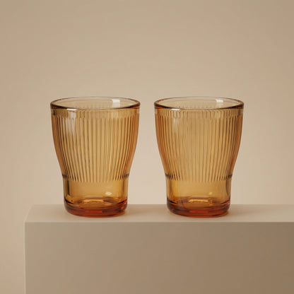 Sienna Glow ribbed amber glass tumbler made of heat-resistant borosilicate glass with elegant vertical texture.SOLA & SIENNA
